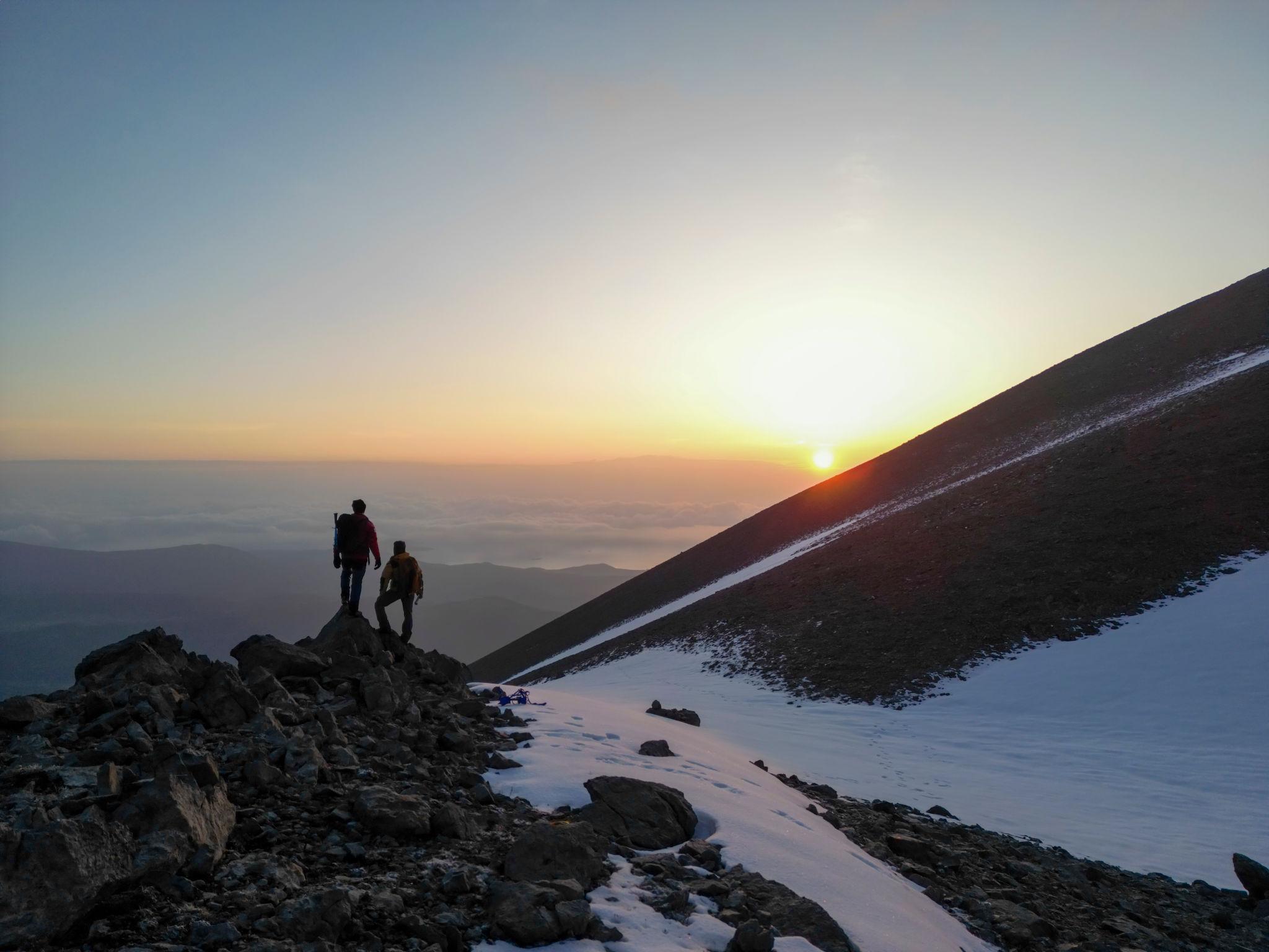 Person climbing a mountain representing growth